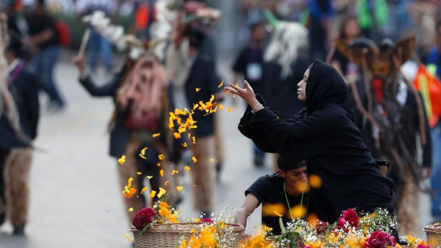 Performers participate in the Day of the Dead parade on Mexico City's main Reforma Avenue.