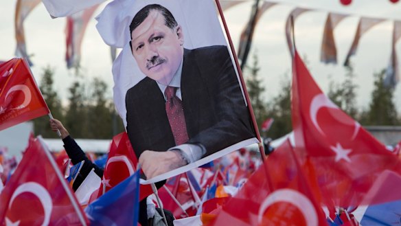 A flag at an election rally bears the likeness of Recep Tayyip Erdogan.