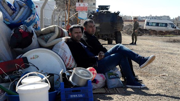Kurds wait at the Mursitpinar border crossing in readiness for a return to Kobane. 