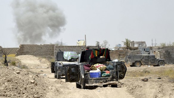 Smoke rises after an airstrike by US-led coalition warplanes as Iraq's elite counterterrorism forces enter Shuhada.