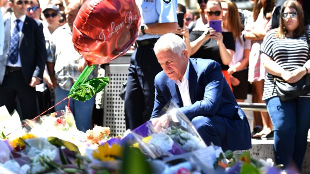 Prime Minister Malcolm Turnbull lays flowers in Bourke Street.