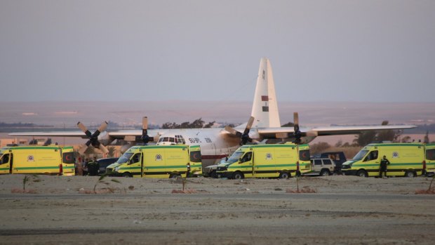 Ambulances line up as emergency workers unload bodies of victims from the crash.