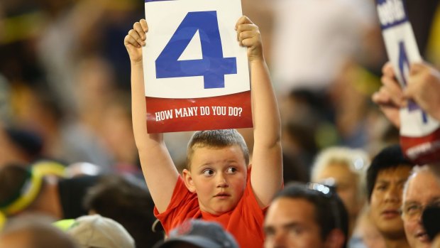 A young fan, one of the 21,415, who turned up to watch the second T20, cheers Australia on.