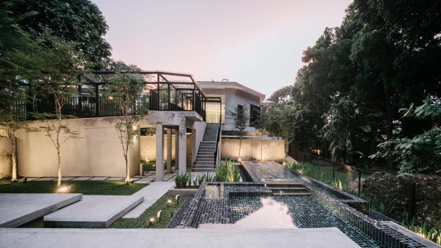 The hotel features a tree-filled garden, a rarity in crowded Singapore.