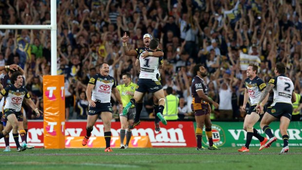 The Cowboys celebrate after Johnathan Thurston kicks the winning point of the 2015 NRL grand final. 