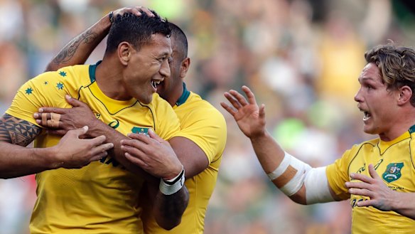 Australia's Israel Folau celebrates with teammates after scoring a try against South Africa.