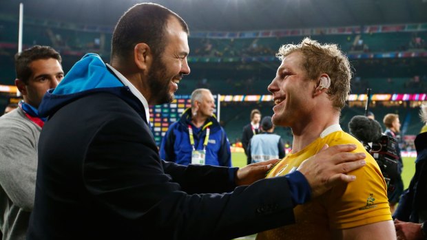 Home away from home: Michael Cheika and David Pocock embrace after the Wallabies beat Argentina at Twickenham.
