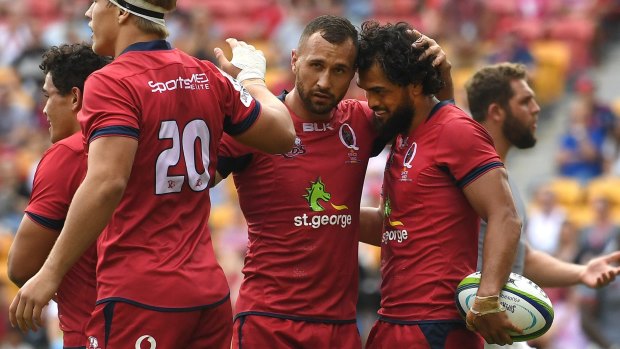 Sticking together: Quade Cooper and Karmichael Hunt celebrate a Queensland try last season. Will they be reunited in a red jersey?