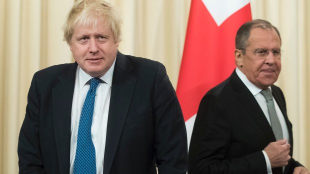 Russian Foreign Minister Sergey Lavrov, right, and British Foreign Secretary Boris Johnson arrive to attend a news conference following their talks in Moscow, Russia.