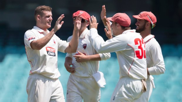Nick Winter (left) celebrates after taking the wicket of Peter Nevill at the SCG.