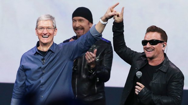 Awkward: The finger touch between Apple chief executive Tim Cook and U2's Bono.