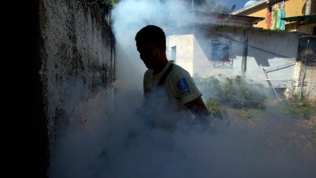 A municipality worker fumigates for mosquitoes in Caracas, Venezuela.