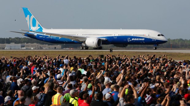 Boeing employees watch the new Boeing 787-10 Dreamliner as it taxis down the runway at Charleston International Airport in North Charleston on Friday.
