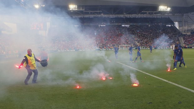 Flares are thrown onto the pitch during the Euro 2016 Group D match between the Czech Republic and Croatia in Saint-Etienne on Friday.