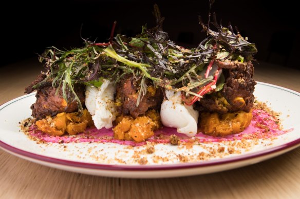 Corn fritters with poached eggs and greens.