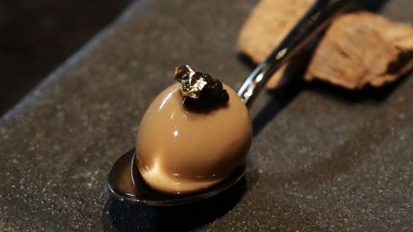 Quail egg topped with caviar and gold leaf.