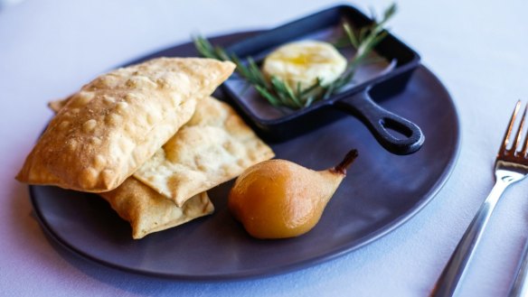 Holy Goat La Luna cheese, rosemary and cumin bread crisps and hay-baked pear at Paringa Estate.
