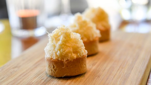 Cheese and pickle tartlets layered with onion chutney, cheddar custard and grated cheese.