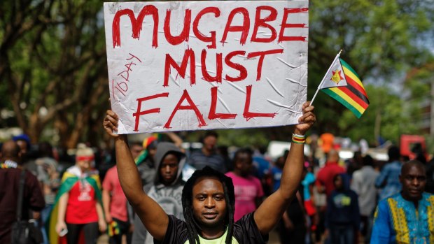 In a euphoric gathering that just days ago would have drawn a police crackdown, crowds marched through Zimbabwe's capital on Saturday to demand the departure of President Robert Mugabe, one of Africa's last remaining liberation leaders, after nearly four decades in power. (AP Photo/Ben Curtis)