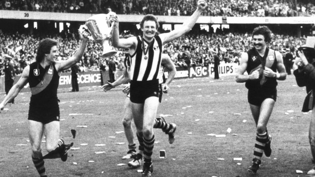Passion: Richmond players Geoff Raines, Michael Roach (wearing a Collingwood guernsey) and Mick Malthouse after their grand final series win in 1980. 