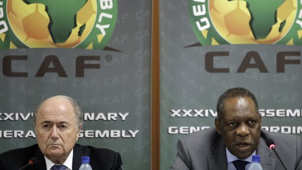 Cameroon's Issa Hayatou (right) will take over FIFA in Sepp Blatter's absence.