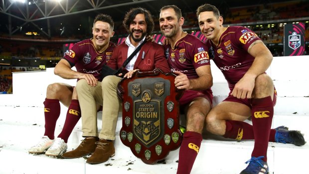 Cooper Cronk, Johnathan Thurston, Cameron Smith and Billy Slater of the Maroons pose with the State of Origin trophy.