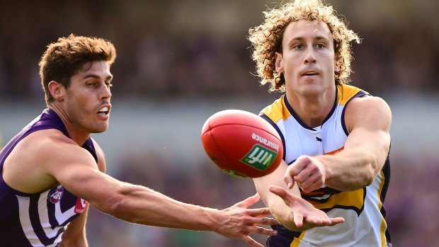 Matt finish: West Coast's Brownlow medal winner handpasses his way out of trouble.