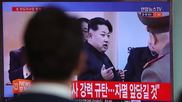 A man in Seoul watches file footage of North Korean leader Kim Jong-un. 
