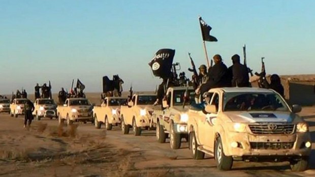 Propaganda for Islamic State shows its fighters in a convoy of vehicles bearing the group's flag.