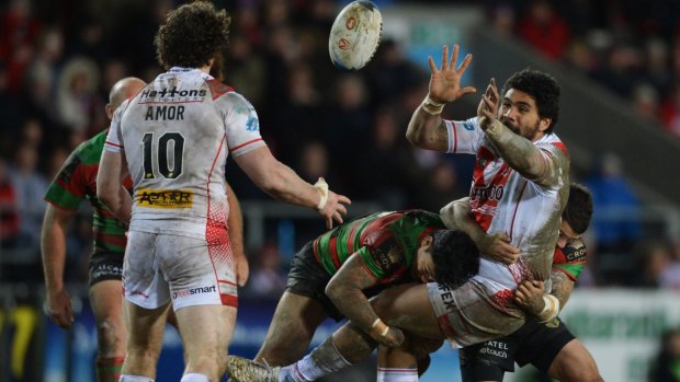 Mose Masoe of St Helens passes the ball.