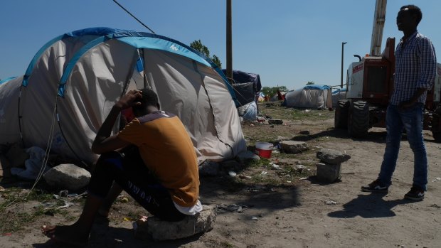 Daniel, an Eritrean, outside his tent in The Jungle in Calais, France, while waiting to go to London last year. One of his feet is injured, from trying to board a truck.
