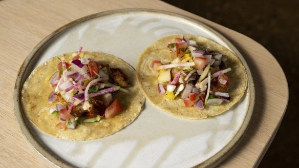 Al pastor tacos with slow-cooked, marinated pork belly, grilled pineapple and watermelon radish.