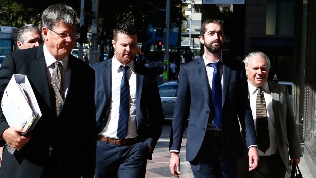 Barry Lyttle (centre) arrives at court with his lawyer Chris Watson (left) and brother Patrick (right).
