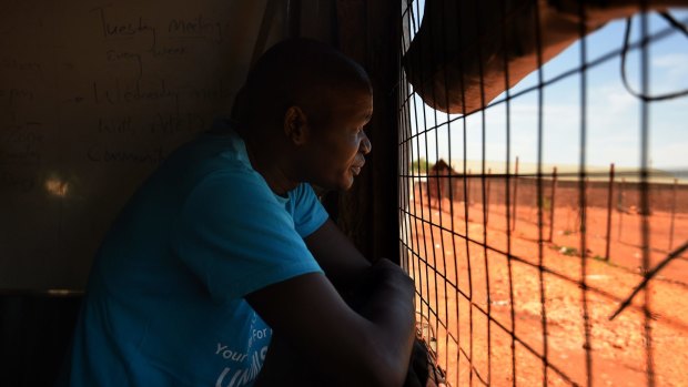 Stephen Makol, the deputy chairperson of Juba Protection of Civilians site sector 3, looks out the window of his office inside the camp.