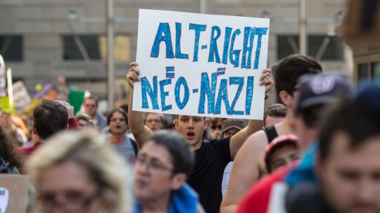 Protesters march outside a conference of the so-called alt-right in Washington.