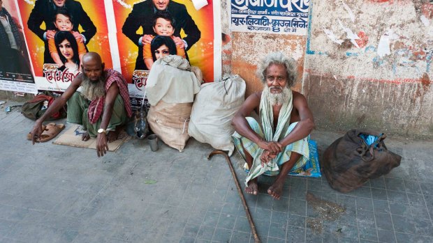 Two homeless men beg for alms in the Chowringhee suburb of Kolkata.