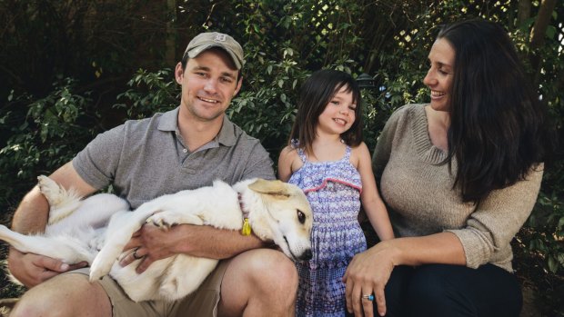 Former United States Marine
Eric Yarger with his wife Olympia and their daughter Charlotte, 4, at home in Isaacs with Snickle Fritz, the dog he rescued from a rubbish dump in Afghanistan.