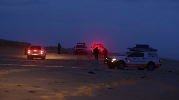Police at the scene where two bodies washed up on Stockton Bight.