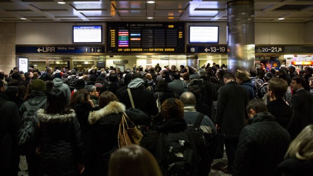 State of emgerency: New Yorkers crowd Penn Station as the snowstorm begins.