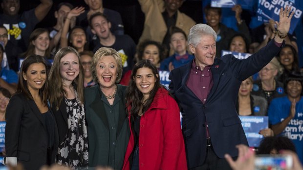Actress Eva Longoria, from left, Chelsea Clinton, Hillary Clinton, actress America Ferrera and Bill Clinton wave to attendees during a campaign rally in Las Vegas. 