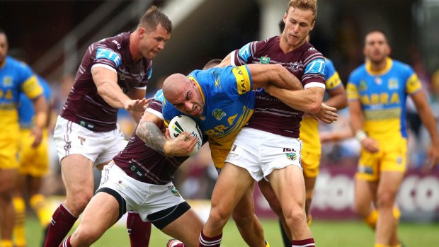 Up the middle: Tim Mannah grinds his way forward.