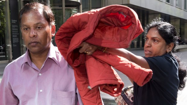 Alleged slavers Kandasamy and Kumuthini Kannan try to conceal their faces as they leave the County Court in February.