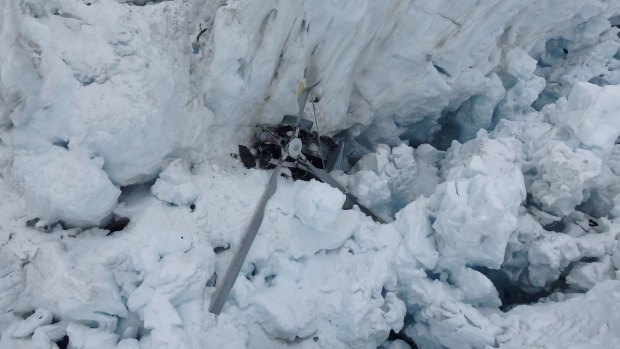 The wreckage of the helicopter, which crashed, killing all seven people on board, is seen in a crevasse on Fox Glacier, New Zealand