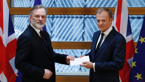 Sir Tim Barrow (left), Britain's permanent representative to the EU, hands Theresa May's Article 50 letter triggering Brexit to the European Council President Donald Tusk in Brussels.