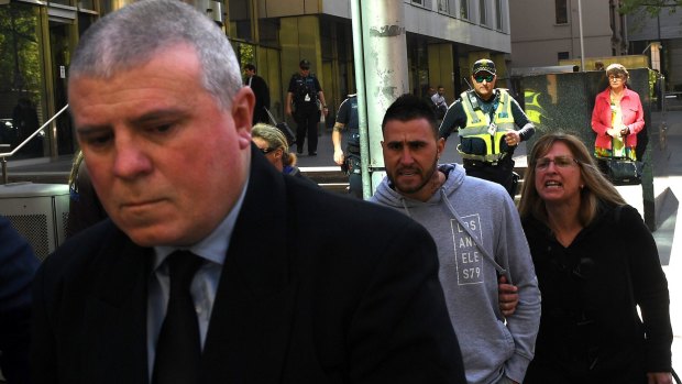 Philip Bracken is heckled as he leaves court on Monday.