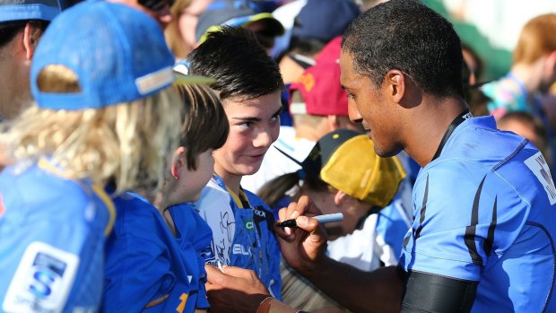 Small but passionate: Marcel Brache of the Force signs autographs at nib Stadium.