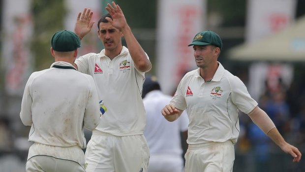 Shining light: Mitchell Starc takes the wicket of Dinesh Chandimal.