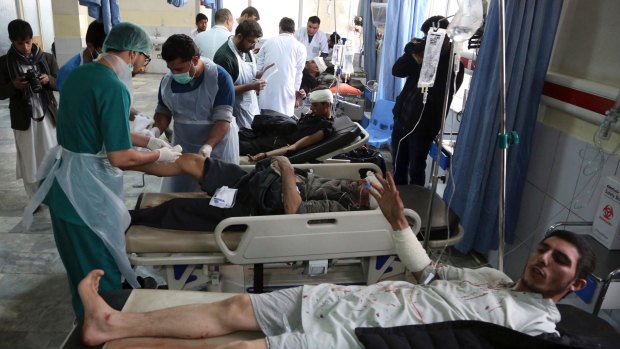 Victims receive treatment in hospital after a suicide attack in Kabul on Saturday.