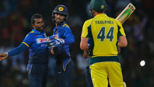Too good: Sri Lanka's Amila Aponso, left, celebrates the dismissal of Australia's James Faulkner.