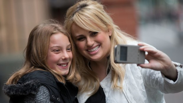 Hollywood actress Rebel Wilson poses with a young fan outside Melbourne's Supreme Court earlier this month. 